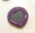 Polymer clay heart pressed into the molding putty.